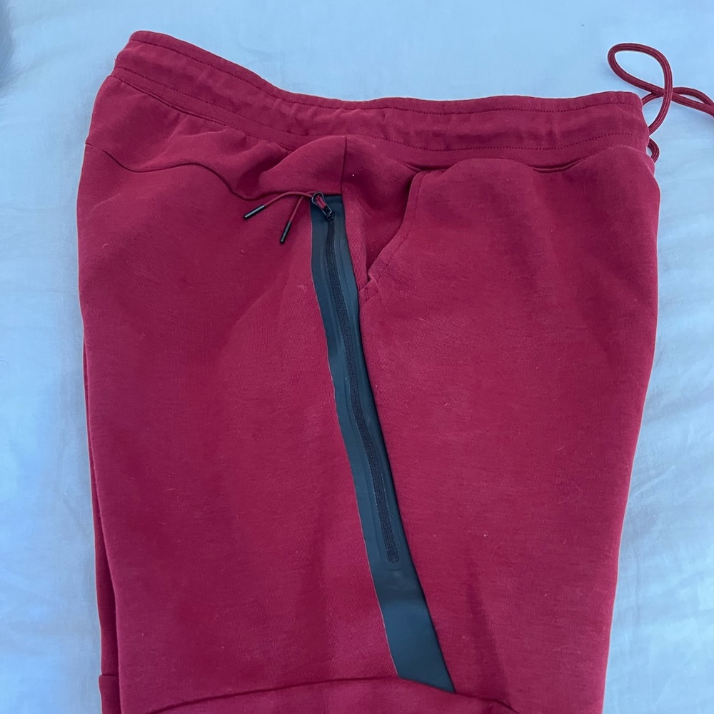 Nike Sportswear Tech Joggers. Size Large. Red color with black details.